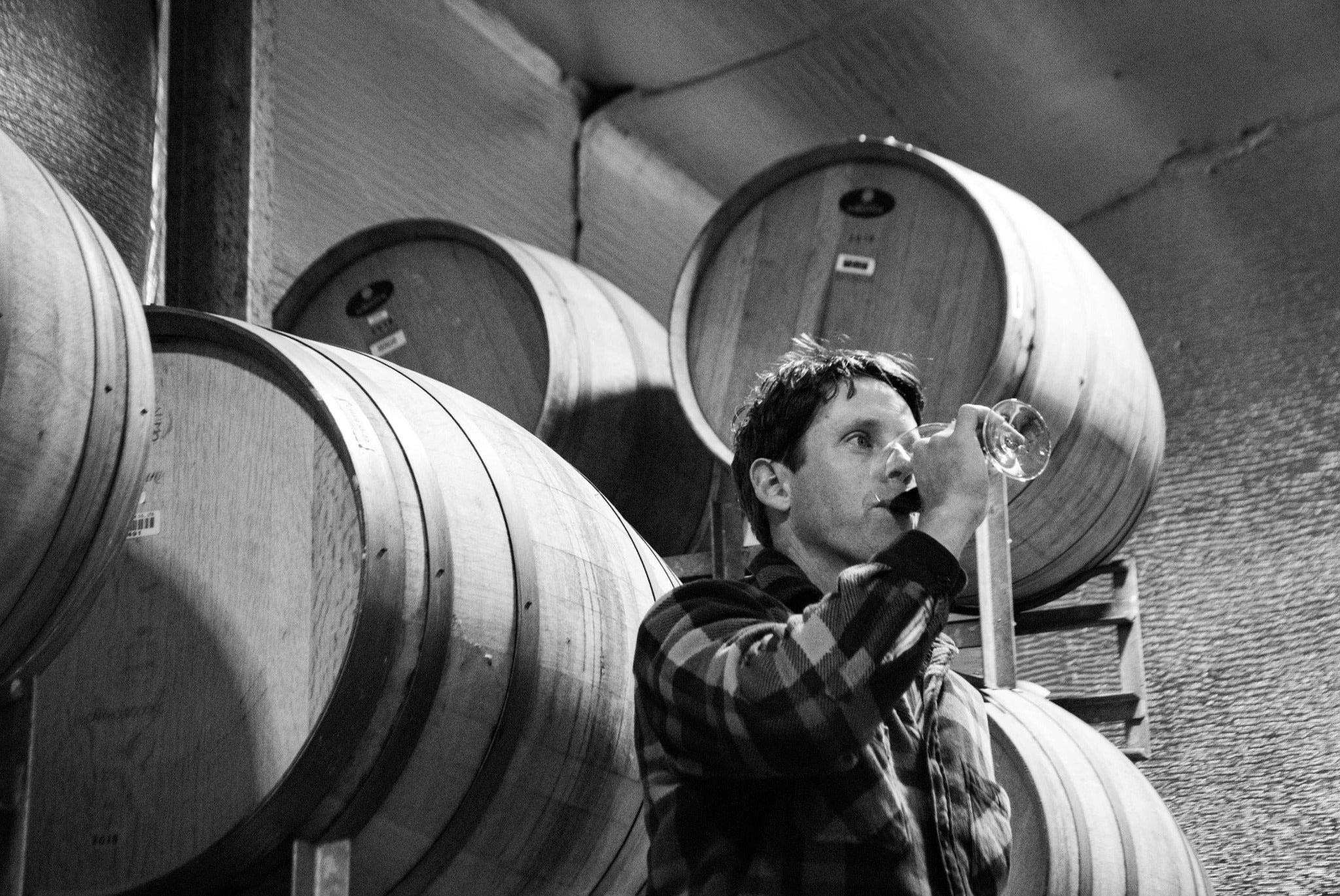 Dan tasting wine among the barrels in the Berrigan winery