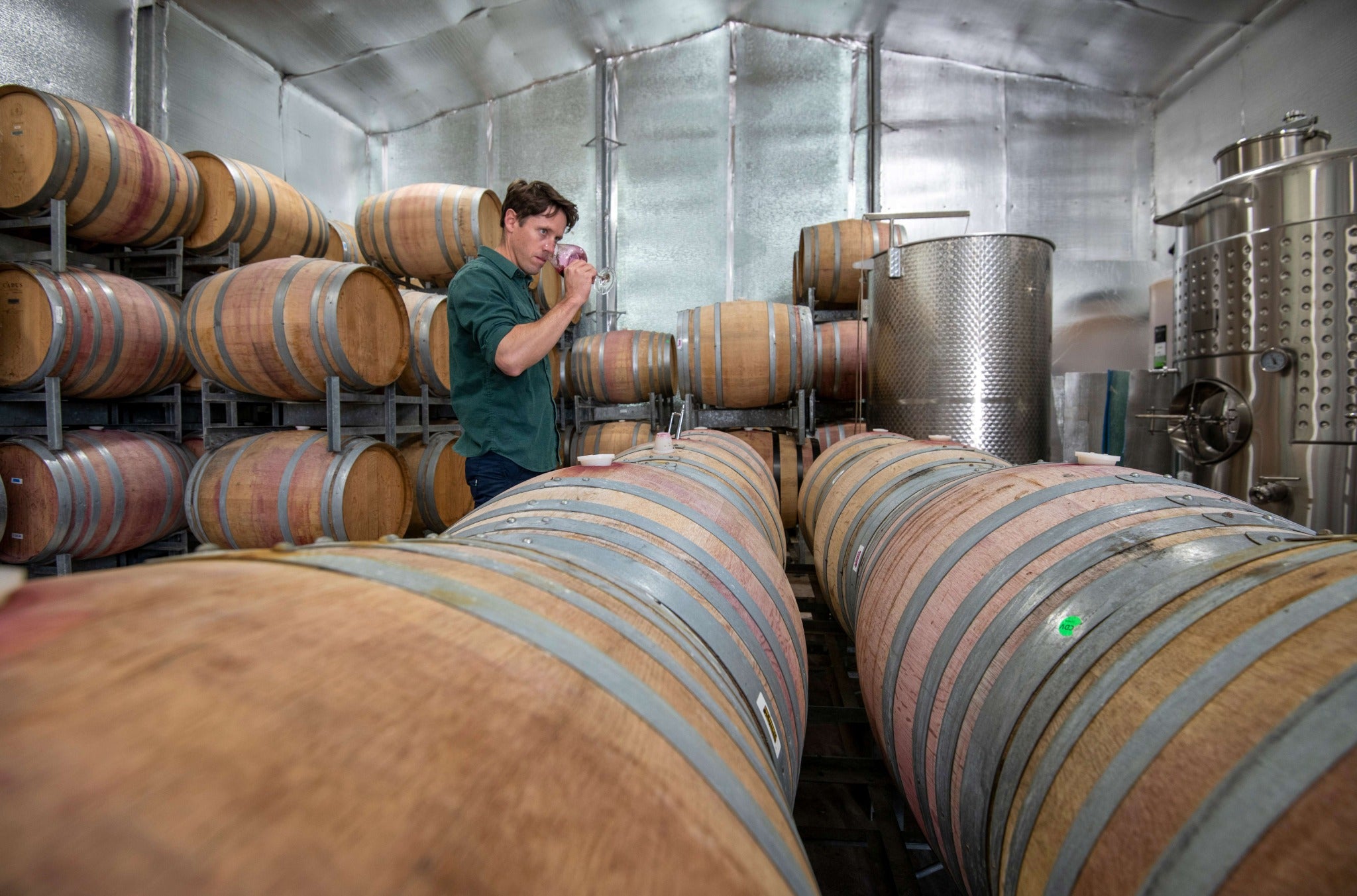 Dan tasting wine among the barrels