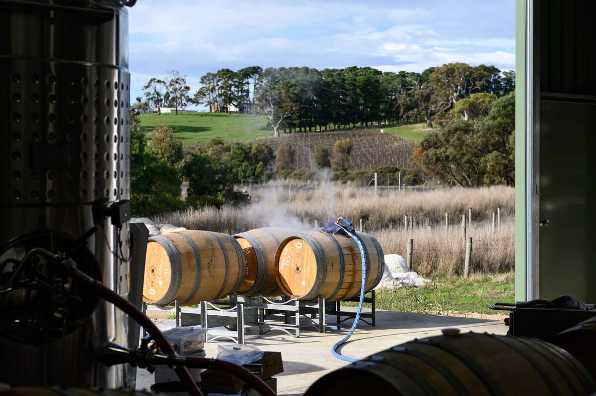 Barrels outside the winery with Shining Rock Vineyard beyond