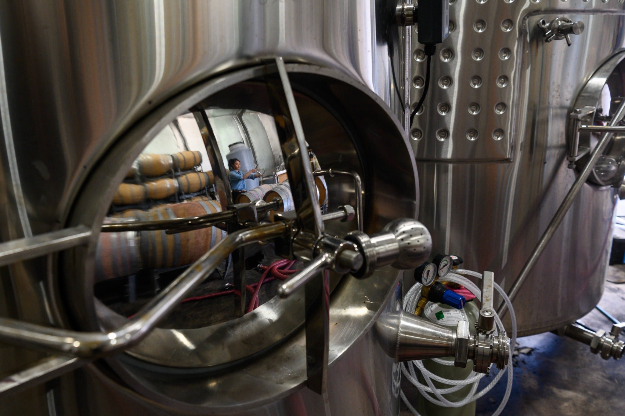 Winery equipment with a reflection of the barrel room